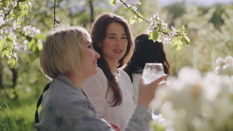 happy-women-are-having-fun-in-garden-party-ladies-are-chatting-joyfully-enjoying-cocktails